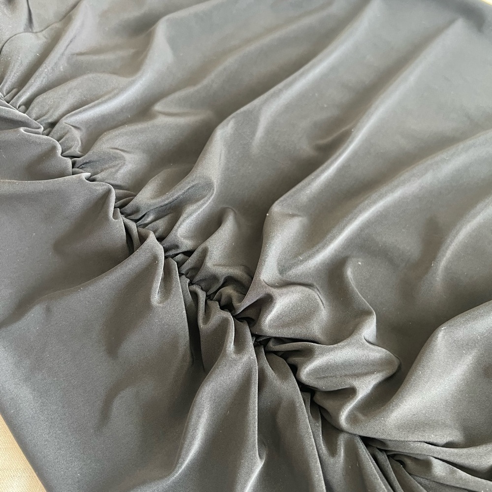 A sleek black mid asymmetrical dress